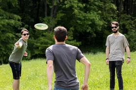 adult-men-having-fun-while-playing-frisbee_1.jpg